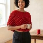 A vibrant scarlet-red capelet-style poncho